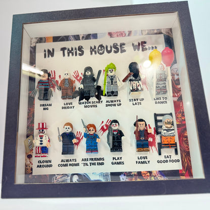 Framed artwork with LEGO figures and text 'In this house we...' on a white background.
