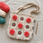 Cream crochet red rose granny square tote bag - handmade flat lay with yarn and crochet hook