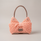 Pink crochet bow mesh shoulder bag - studio hero shot